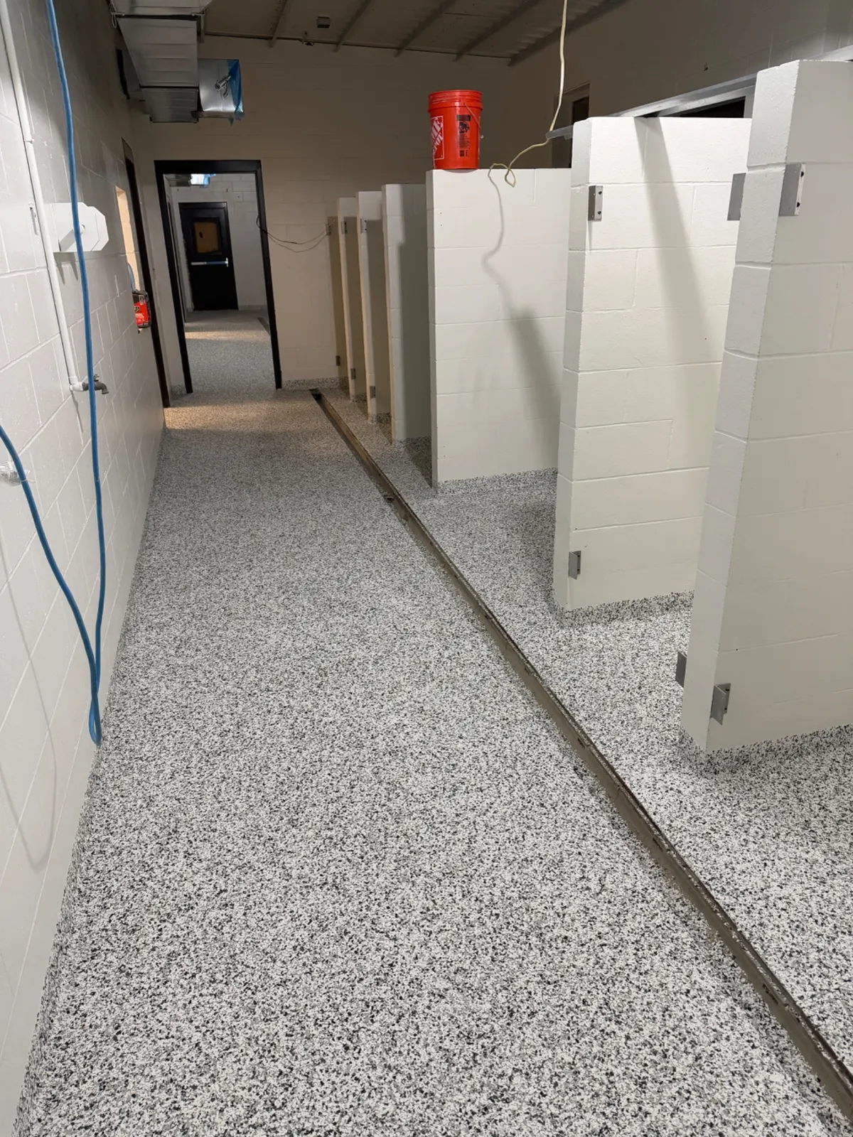Commercial wet-area resinous flooring with floor drains